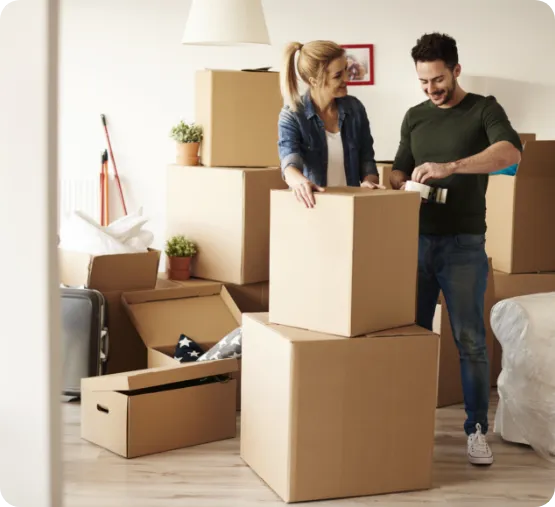 man and woman taping boxes