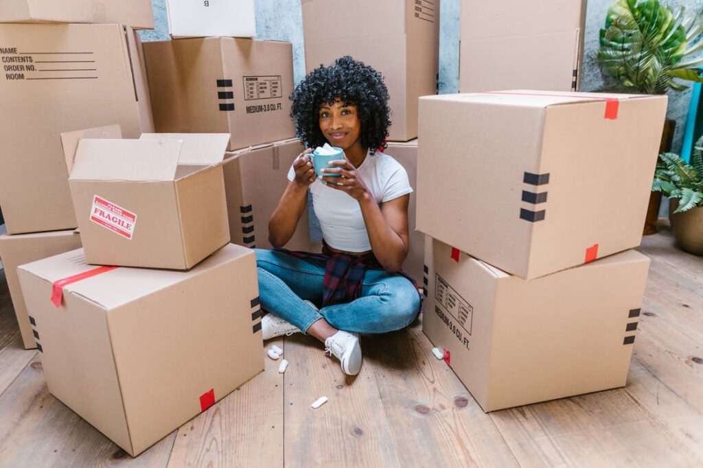 woman sitting in front of boxes