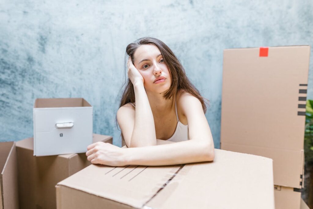 tired woman leaning on box
